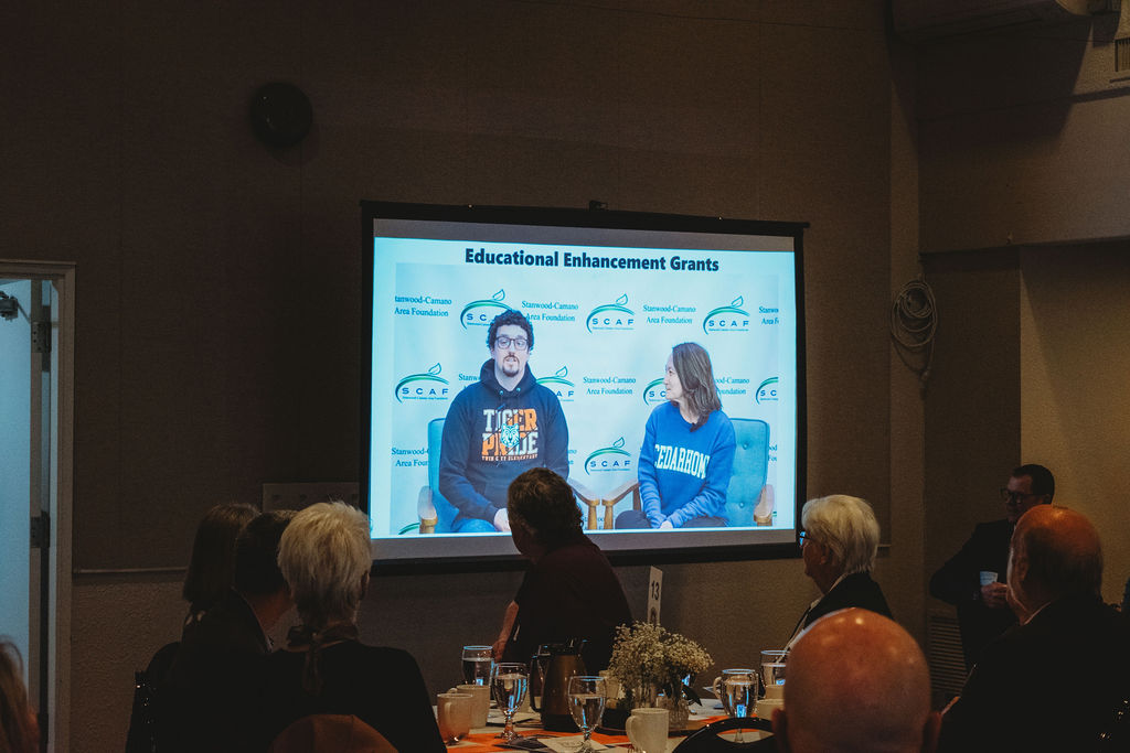 Zach Pfrimmer and Diana Laws are on a video screen